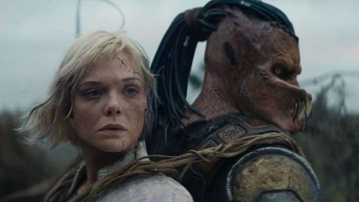 (L-R) Thia (Elle Fanning) and Dek (Dimitrius Schuster-Koloamatangi) in 20th Century Studios' PREDATOR: BADLANDS film.