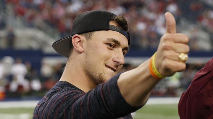 Sep 27, 2014; Arlington, TX, USA; Texas A&M Aggies former quarterback Johnny Manziel is presented his Aggie ring during a ceremony at halftime against the Arkansas Razorbacks at AT&T Stadium. Mandatory Credit: Matthew Emmons-USA TODAY Sports