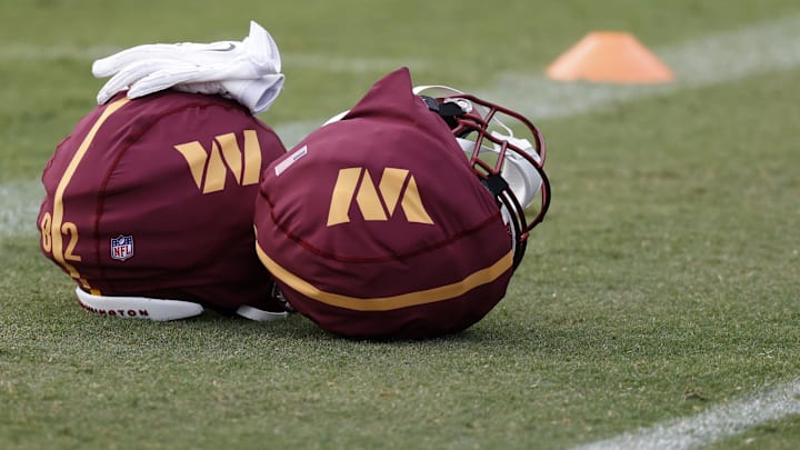 Jul 26, 2024; Ashburn, VA, USA; Washington Commanders players' helmets rest on the field on day three of training camp at Commanders Park.  