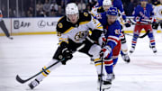 Feb 5, 2025; New York, New York, USA; Boston Bruins center Morgan Geekie (39) controls the puck against New York Rangers right wing Reilly Smith (91) during the first period at Madison Square Garden. Mandatory Credit: Brad Penner-Imagn Images