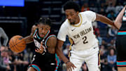Oct 22, 2025; Memphis, Tennessee, USA; Memphis Grizzlies guard Ja Morant (12) dribbles as New Orleans Pelicans forward Herbert Jones (2) defends during the first quarter at FedExForum. Mandatory Credit: Petre Thomas-Imagn Images