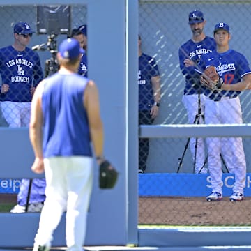 Dodgers starting pitcher Clayton Kershaw (22), left, looks on as designated hitter Shohei Ohtani (17) throws in the bullpen prior to the game against the Arizona Diamondbacks at Dodger Stadium on May 21.