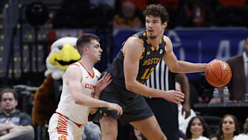Mar 13, 2024; Washington, D.C., USA; Boston College Eagles forward Quinten Post (12) dribbles the ball as Clemson Tigers guard Joseph Girard III (11) defends in the second half at Capital One Arena. Mandatory Credit: Geoff Burke-Imagn Images