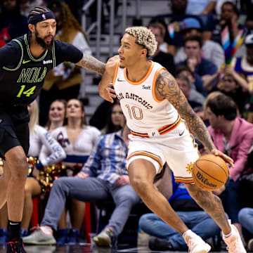 Dec 1, 2023; New Orleans, Louisiana, USA; San Antonio Spurs forward Jeremy Sochan (10) dribbles against New Orleans Pelicans forward Brandon Ingram (14) during the second half at the Smoothie King Center.