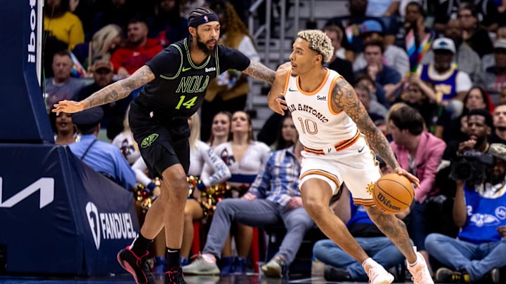 Dec 1, 2023; New Orleans, Louisiana, USA; San Antonio Spurs forward Jeremy Sochan (10) dribbles against New Orleans Pelicans forward Brandon Ingram (14) during the second half at the Smoothie King Center.