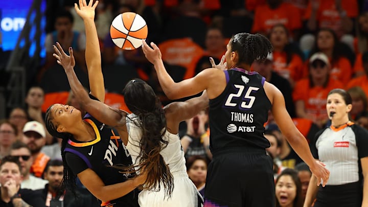 Oct 8, 2025; Phoenix, Arizona, USA; Phoenix Mercury guard Monique Akoa Makani (8),forward Alyssa Thomas (25) and Las Vegas Aces guard Jackie Young (0) attempt to get a rebound in the second half during game three of the 2025 WNBA Finals at PHX Arena. Mandatory Credit: Mark J. Rebilas-Imagn Images