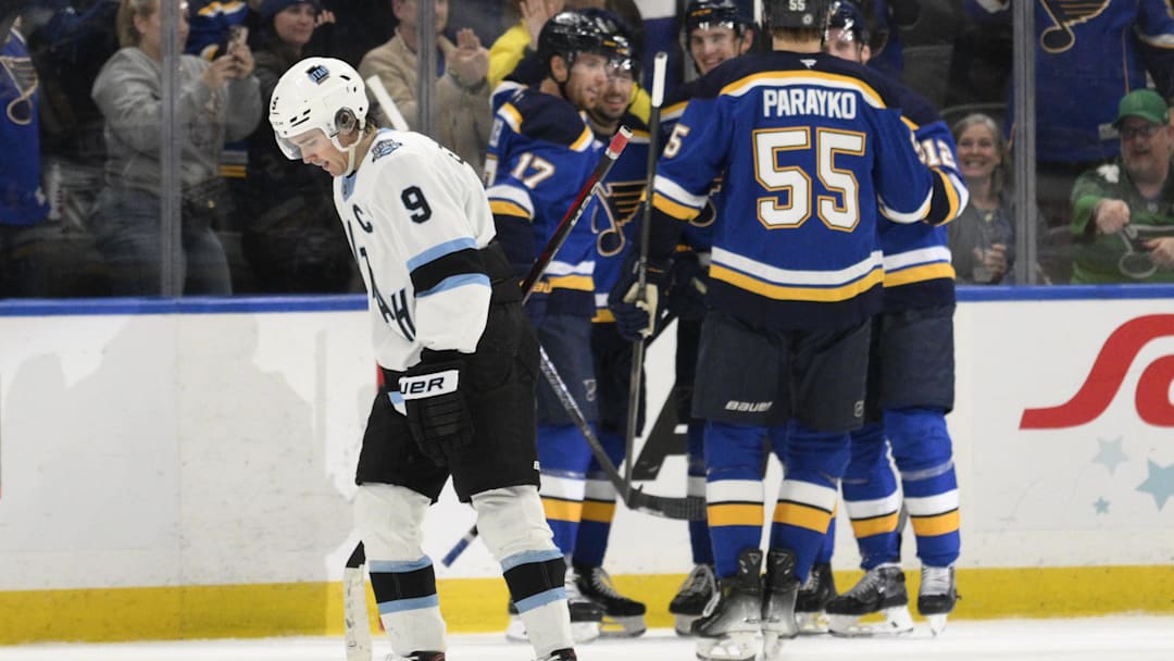 Apr 15, 2025; St. Louis, Missouri, USA; Utah Hockey Club center Clayton Keller (9) looks on as St. Louis Blues right wing Jordan Kyrou (25) is congratulated by teammates for scoring during the third period at Enterprise Center. Mandatory Credit: Jeff Le-Imagn Images