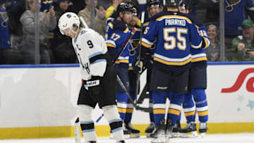 Apr 15, 2025; St. Louis, Missouri, USA; Utah Hockey Club center Clayton Keller (9) looks on as St. Louis Blues right wing Jordan Kyrou (25) is congratulated by teammates for scoring during the third period at Enterprise Center. Mandatory Credit: Jeff Le-Imagn Images
