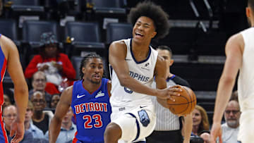 Oct 6, 2025; Memphis, Tennessee, USA; Memphis Grizzlies forward Jaylen Wells (0) drives to the basket as Detroit Pistons guard Jaden Ivey (23) defends during the first quarter at FedExForum. Mandatory Credit: Petre Thomas-Imagn Images