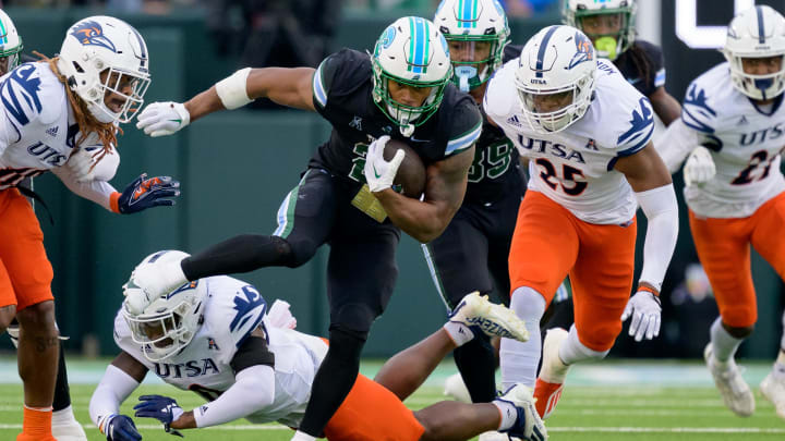 Nov 24, 2023; New Orleans, Louisiana, USA; Tulane Green Wave running back Makhi Hughes (21) runs against UTSA Roadrunners safety Rashad Wisdom (0) during the first half at Yulman Stadium. 