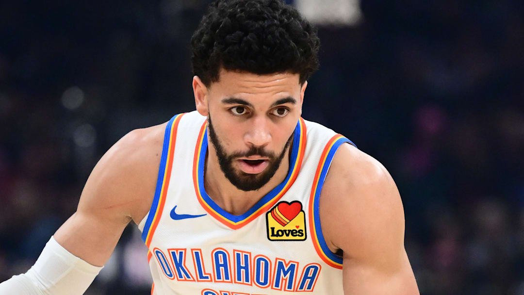Jan 19, 2026; Cleveland, Ohio, USA; Oklahoma City Thunder guard Ajay Mitchell (25) brings the ball up court against the Cleveland Cavaliers during the first half at Rocket Arena. Mandatory Credit: Ken Blaze-Imagn Images