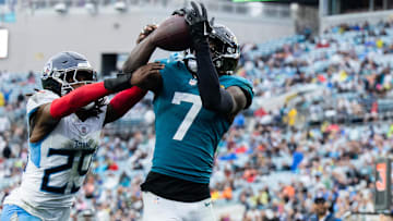 Dec 29, 2024; Jacksonville, Florida, USA; Jacksonville Jaguars wide receiver Brian Thomas Jr (7) catches the ball for a touchdown against Tennessee Titans cornerback Jarvis Brownlee Jr. (29) in the fourth quarter at EverBank Stadium. Mandatory Credit: Jeremy Reper-Imagn Images