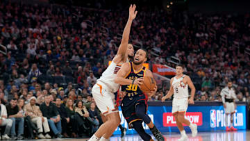 Jan 31, 2025; San Francisco, California, USA; Golden State Warriors guard Stephen Curry (30) is fouled by Phoenix Suns guard Devin Booker (1) in the fourth quarter at the Chase Center. Mandatory Credit: Cary Edmondson-Imagn Images