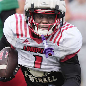 Louisville Isaac Brown (1) runs for a first down against Red Louisville in the Spring Game Friday night at L&N Stadium