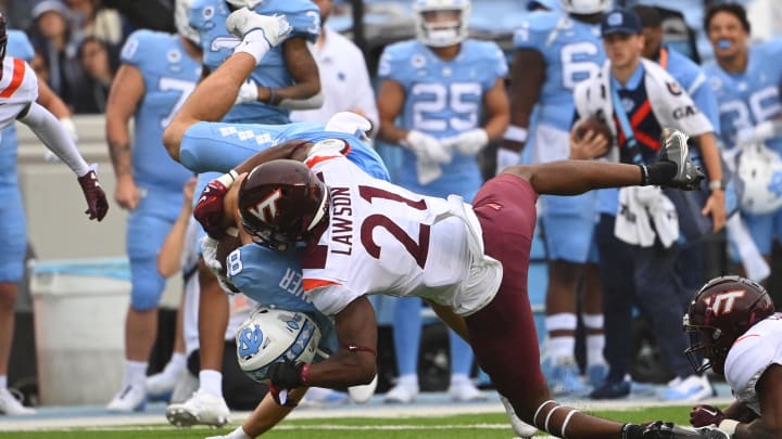 Oct 1, 2022; Chapel Hill, North Carolina, USA; North Carolina Tar Heels tight end John Copenhaver (81) is tackled by Virginia Tech Hokies linebacker Keli Lawson (21) in the first quarter at Kenan Memorial Stadium. Mandatory Credit: Bob Donnan-USA TODAY Sports