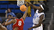 Feb 23, 2025; Los Angeles, California, USA; UCLA Bruins forward William Kyle III (24) blocks a shot by Ohio State Buckeyes guard Micah Parrish (8) during the second half at Pauley Pavilion presented by Wescom. Mandatory Credit: Robert Hanashiro-Imagn Images