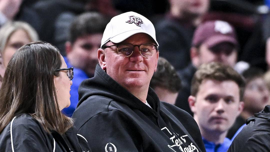 Texas A&M Aggies head football coach Mike Elko sits courtside during the Men’s basketball game against the Florida Gators