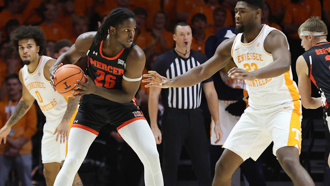 Nov 3, 2025; Knoxville, Tennessee, USA;  Mercer Bears center Armani Mighty (26) looks to moves the ball against Tennessee Volunteers forward Jaylen Carey (23) during the first half at Thompson-Boling Arena at Food City Center. Mandatory Credit: Randy Sartin-Imagn Images