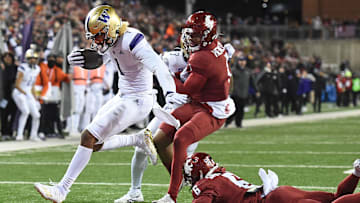 Nov 26, 2022; Pullman, Washington, USA; Washington Huskies wide receiver Rome Odunze (1) jumps into he end zone for a touchdown against Washington State Cougars defensive back Chau Smith-Wade (6) in the second half at Gesa Field at Martin Stadium. Washington won 51-33. Mandatory Credit: James Snook-Imagn Images