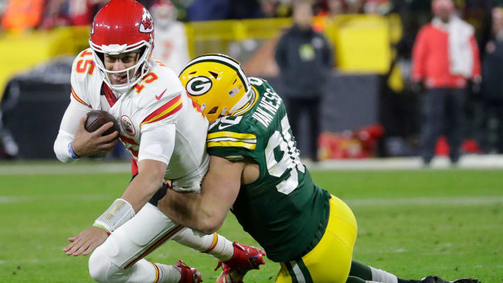 Green Bay Packers defender Lukas Van Ness (90) sacks Kansas City Chiefs quarterback Patrick Mahomes (15) at Lambeau Field.