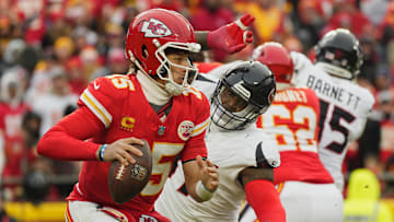 Jan 18, 2025; Kansas City, Missouri, USA; Kansas City Chiefs quarterback Patrick Mahomes (15) runs the ball against Houston Texans defensive tackle Mario Edwards Jr. (97) during the second quarter of a 2025 AFC divisional round game at GEHA Field at Arrowhead Stadium. Mandatory Credit: Jay Biggerstaff-Imagn Images