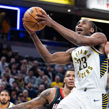 Mar 4, 2025; Indianapolis, Indiana, USA; Indiana Pacers forward Aaron Nesmith (23) shoots the ball while Houston Rockets forward Dillon Brooks (9)  defends in the second half at Gainbridge Fieldhouse. Mandatory Credit: Trevor Ruszkowski-Imagn Images