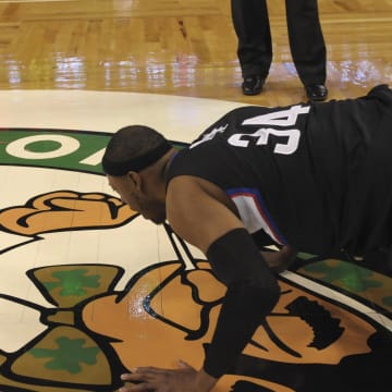 Feb 5, 2017; Boston, MA, USA;  LA Clippers forward Paul Pierce (34) kisses the parquet floor one last time during a game against the Boston Celtics at TD Garden. Mandatory Credit: Bob DeChiara-USA TODAY Sports
