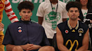 Mar 31, 2025; Brooklyn, New York, USA; McDonald’s All Americans East forward Cameron Boozer (12), left, and East guard Cayden Boozer (2), right, sit on the court during the Sprite Jam Fest at Barclay's Center.