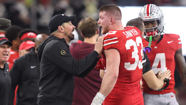 Ohio State head coach Ryan Day and defensive end Jack Sawyer celebrate after winning the College Football Playoff semifinal.