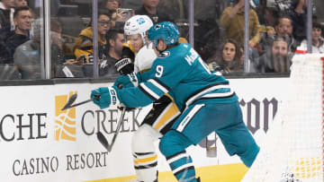 Feb 14, 2023; San Jose, California, USA; San Jose Sharks defenseman Jacob MacDonald (9) checks Pittsburgh Penguins center Jake Guentzel (59) into the boards during the third period at SAP Center at San Jose. Mandatory Credit: D. Ross Cameron-USA TODAY Sports