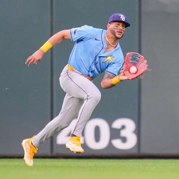 Jun 18, 2024; Minneapolis, Minnesota, USA; Tampa Bay Rays outfielder Jose Siri (22) fields a fly ball against the Minnesota Twins in the fourth inning at Target Field.