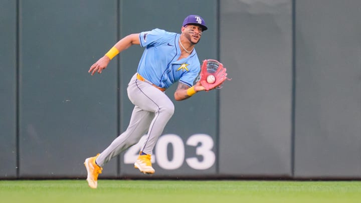 Jun 18, 2024; Minneapolis, Minnesota, USA; Tampa Bay Rays outfielder Jose Siri (22) fields a fly ball against the Minnesota Twins in the fourth inning at Target Field.
