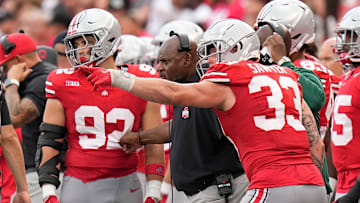 Aug 31, 2024; Columbus, OH, USA; Ohio State Buckeyes defensive end Jack Sawyer (33) points out a play to coach Larry Johnson during the second half of the NCAA football game against the Akron Zips at Ohio Stadium. Ohio State won 52-6.