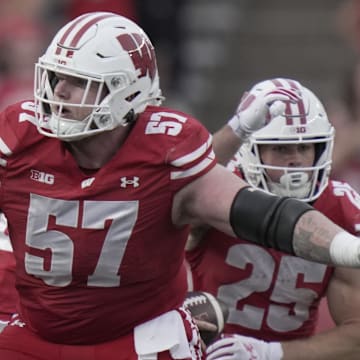 Oct 18, 2025; Madison, Wisconsin, USA;  Wisconsin offensive lineman Jake Renfro (57) provides pas protection during the fourth quarter of their game against Ohio State at Camp Randall Stadium.