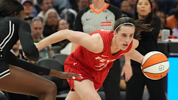 Jun 19, 2025; San Francisco, California, USA; Indiana Fever guard Caitlin Clark (right) dribbles against Golden State Valkyries forward Laeticia Amihere (left) during the third quarter at Chase Center. Mandatory Credit: Darren Yamashita-Imagn Images