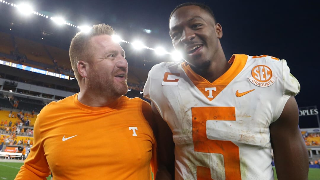 Sep 10, 2022; Pittsburgh, Pennsylvania, USA;  Tennessee Volunteers offensive coordinator Alex Golesh (left) and quarterback Hendon Hooker (5) celebrate as they leave the field after defeating the Pittsburgh Panthers at Acrisure Stadium. Tennessee won 34-27 in overtime. Mandatory Credit: Charles LeClaire-Imagn Images