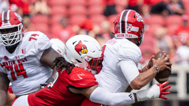 Louisville Cardinals defensive lineman Tramel Logan (19) tackles Austin Peay Governors quarterback Austin Smith (4) during their game on Saturday, Aug. 31, 2024 at L&N Federal Credit Union Stadium in Louisville, Ky.