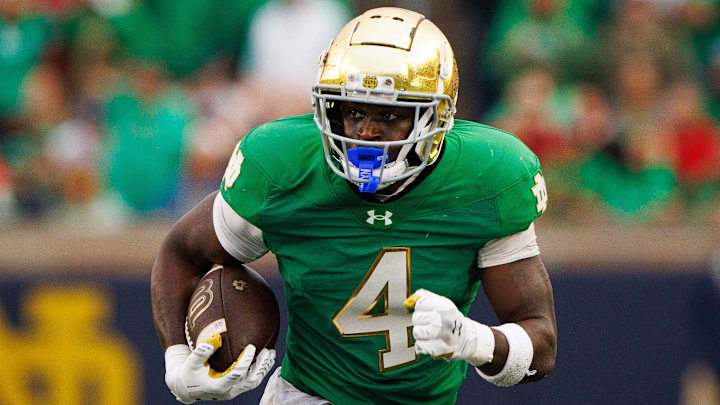 Notre Dame running back Jeremiyah Love runs the ball down the field during an NCAA college football game between Notre Dame and Louisville. Notre Dame running back Jeremiyah Love runs the ball down the field during an NCAA college football game between Notre Dame and Louisville.