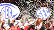 Dec 6, 2025; Atlanta, GA, USA; The Georgia Bulldogs are presented with the SEC Championship trophy after the title football game against the Alabama Crimson Tide at Mercedes-Benz Stadium. 