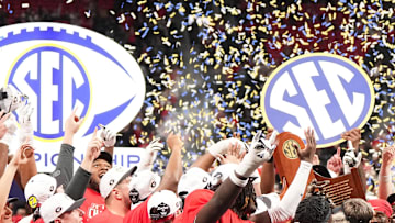 Dec 6, 2025; Atlanta, GA, USA; The Georgia Bulldogs are presented with the SEC Championship trophy after the title football game against the Alabama Crimson Tide at Mercedes-Benz Stadium. 