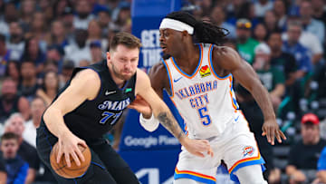 May 18, 2024; Dallas, Texas, USA; Dallas Mavericks guard Luka Doncic (77) controls the ball as Oklahoma City Thunder guard Luguentz Dort (5) defends during the first quarter in game six of the second round of the 2024 NBA playoffs at American Airlines Center. Mandatory Credit: Kevin Jairaj-Imagn Images