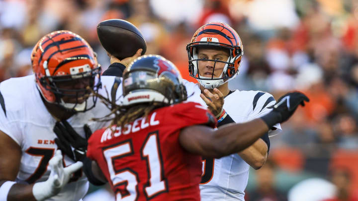 Aug 10, 2024; Cincinnati, Ohio, USA; Cincinnati Bengals quarterback Joe Burrow (9) throws a pass against Tampa Bay Buccaneers linebacker J.J. Russell (51) in the first half at Paycor Stadium. Mandatory Credit: Katie Stratman-USA TODAY Sports