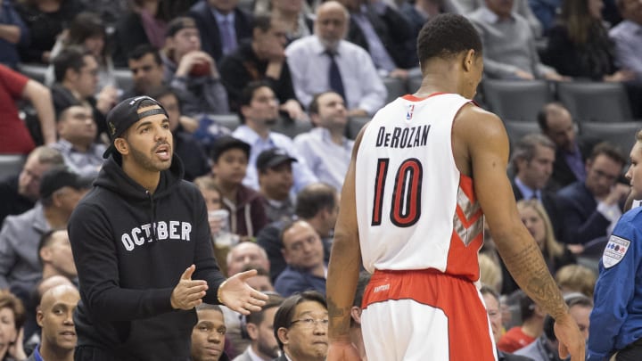 Feb 4, 2015; Toronto, Ontario, CAN; Canadian rapper, songwriter, and actor Drake talks to Toronto Raptors guard DeMar DeRozan (10) during the fourth quarter in a game against the Brooklyn Nets at Air Canada Centre.The Brooklyn Nets won 109-93. Mandatory Credit: Nick Turchiaro-USA TODAY Sports