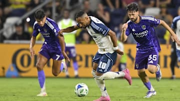 Aug 23, 2025; Nashville, Tennessee, USA;  Nashville SC midfielder Hany Mukhtar (10) splits Orlando City forward Ramiro Enrique (7) and midfielder Joran Gerbet (35) during the second half at Geodis Park. Mandatory Credit: Steve Roberts-Imagn Images
