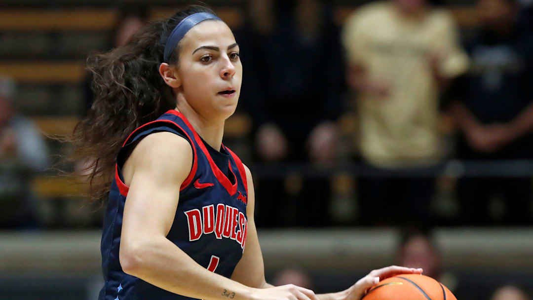 Duquesne Dukes guard Megan McConnell (4) drives to the basket during the NCAA WNIT basketball game against the Purdue Boilermakers, Thursday, March 28, 2024, at Mackey Arena in West Lafayette, Ind.