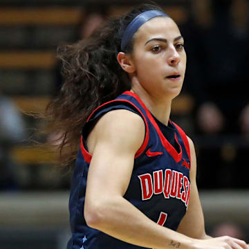 Duquesne Dukes guard Megan McConnell (4) drives to the basket during the NCAA WNIT basketball game against the Purdue Boilermakers, Thursday, March 28, 2024, at Mackey Arena in West Lafayette, Ind.