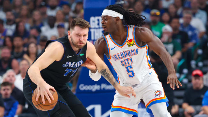 May 18, 2024; Dallas, Texas, USA; Dallas Mavericks guard Luka Doncic (77) controls the ball as Oklahoma City Thunder guard Luguentz Dort (5) defends during the first quarter in game six of the second round of the 2024 NBA playoffs at American Airlines Center. Mandatory Credit: Kevin Jairaj-USA TODAY Sports