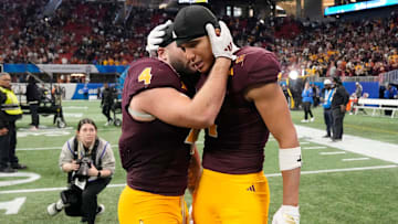 Arizona State running back Cam Skattebo (4) hugs wide receiver Xavier Guillory (1) after Texas won 39-31 over Arizona State in double overtime in the Chick-fil-A Peach Bowl in Atlanta on Wednesday, Jan. 1, 2025.