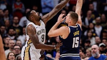 Oct 29, 2025; Denver, Colorado, USA; Denver Nuggets center Nikola Jokic (15) shoots the ball under pressure from New Orleans Pelicans center DeAndre Jordan (9) in the first quarter at Ball Arena. Mandatory Credit: Isaiah J. Downing-Imagn Images