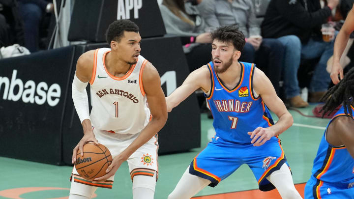 Jan 24, 2024; San Antonio, Texas, USA;  San Antonio Spurs center Victor Wembanyama (1) looks to pass in front of Oklahoma City Thunder forward Chet Holmgren (7) in the first half at Frost Bank Center. Mandatory Credit: Daniel Dunn-USA TODAY Sports